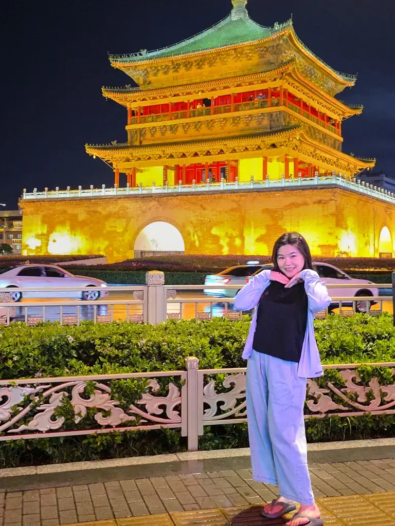 西安旅遊景點:在迷人金色夜景下的西安鐘樓廣場拍照留念